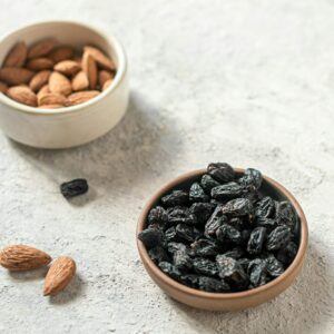 Rosinen und Mandeln in einer kleinen Schale.