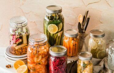 Verschiedene Gläser befüllt mit eingelegtem Gemüse zur Fermentation.