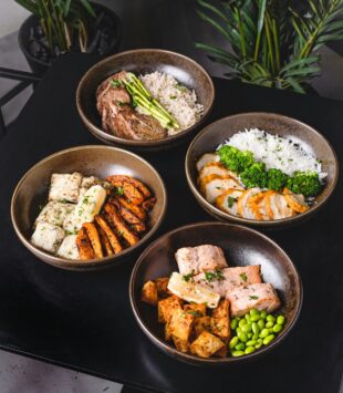 Verschiedene Teller, mit Lachs Bowls mit Reis und grünem Gemüse.