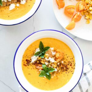 Eine Schale mit Kürbissuppe getoppt mit Kürbiskernen und Feta.