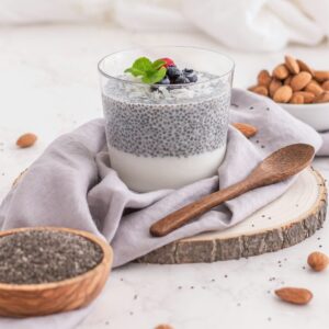 Ein Glas Chia-Hafer-Brei mit Nüssen und Obst.