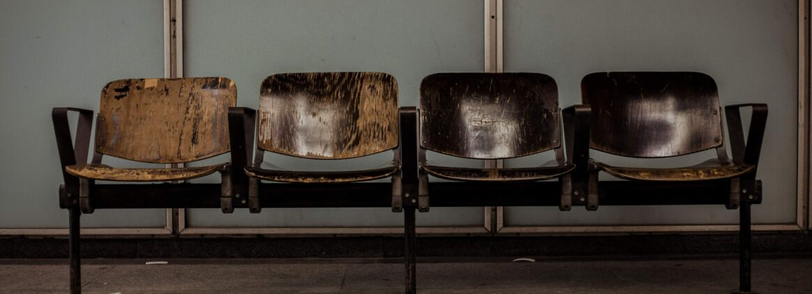 Four brown chairs in a waiting room