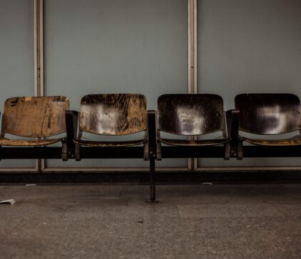 Four brown chairs in a waiting room