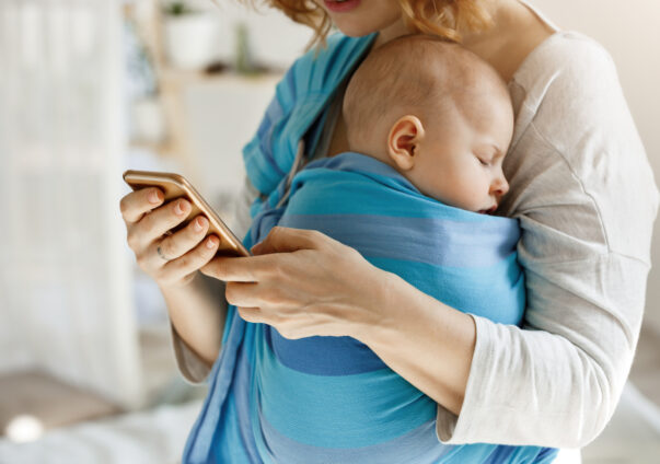 Baby sleeping in a wrap on mother