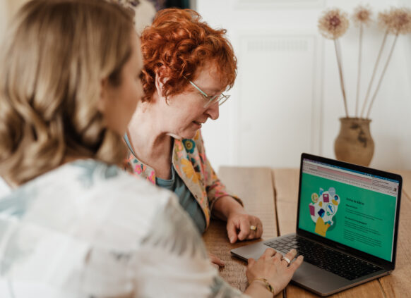 Two women using weight loss programme online