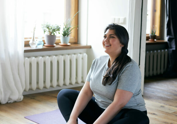 Cheerful young overweight woman in activewear