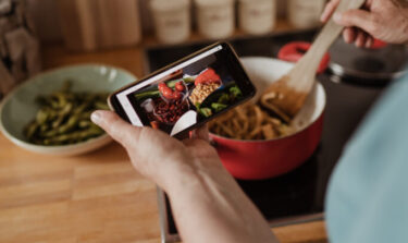 Person cooking healthy meal from a recipe app