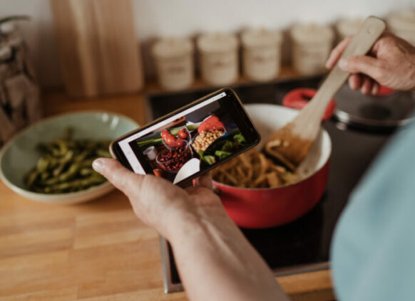 Person cooking healthy meal from a recipe app