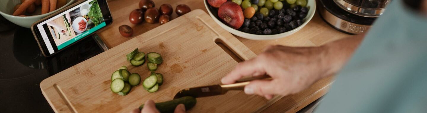 Person using recipe app to cook healthy meal