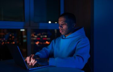 Man using a laptop at night