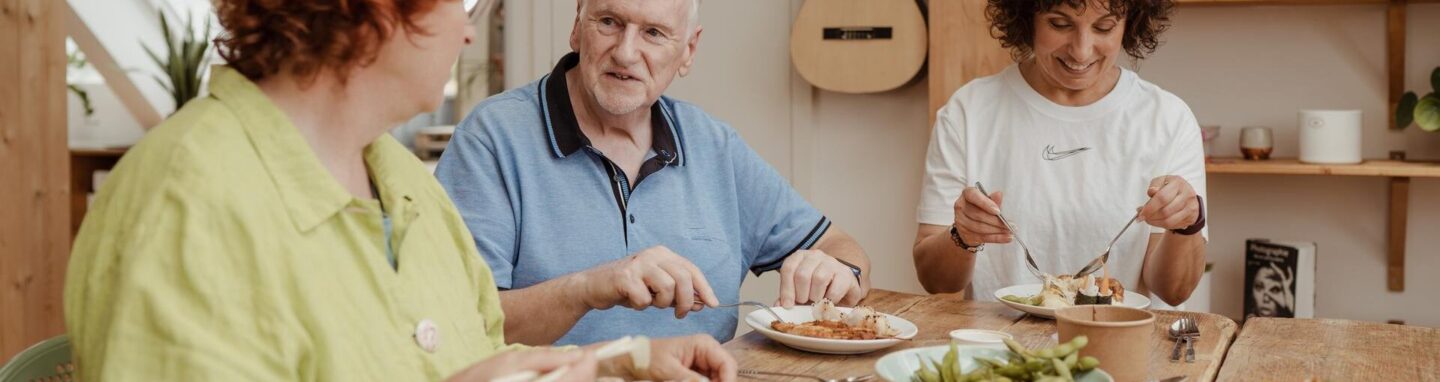 People eating a meal together round a table