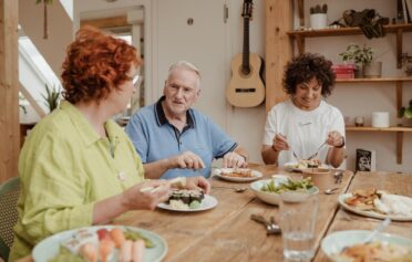 People eating a meal together round a table