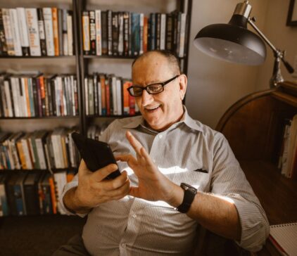 Man looking at phone and laughing