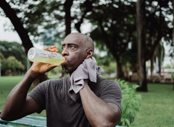 Man drinking a healthier alternative to sugary drinks after exercising