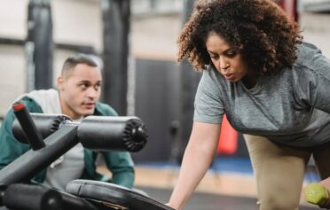 Woman exercising with personal trainer