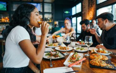 People enjoying a meal and wine together
