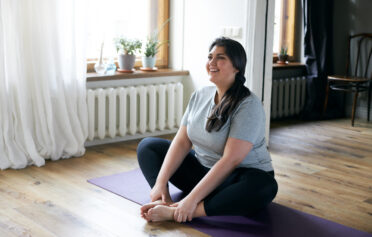 Woman stretching on exercise mat