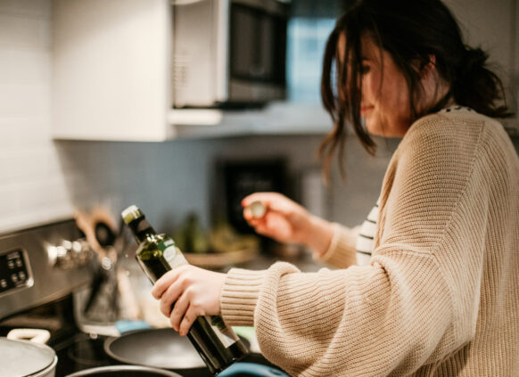 Woman cooking with oil