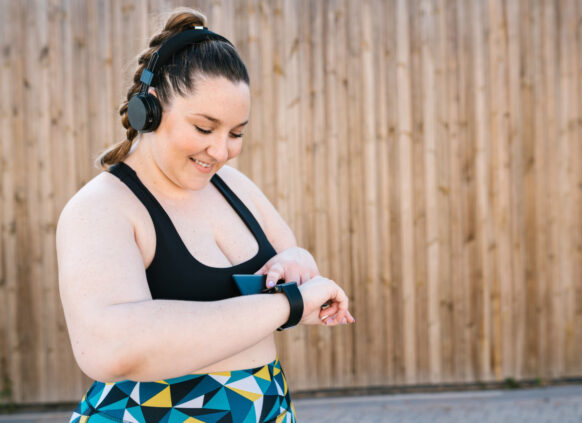 Woman in exercise wear checking her smartwatch