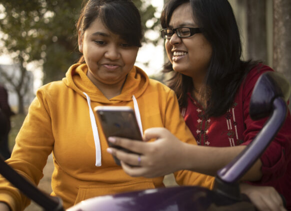 Women looking at phone together