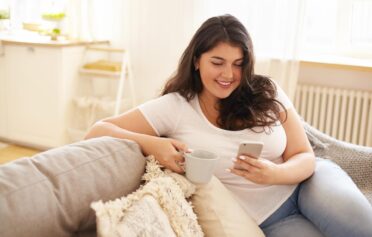 Woman looking at her phone happily