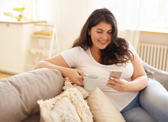 Woman looking at her phone happily