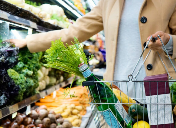 Person shopping fruits and vegetables in a supermarket