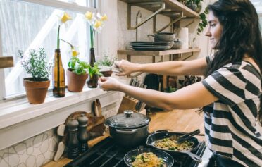 Woman managing weight by cooking a healthy meal with fresh ingredients