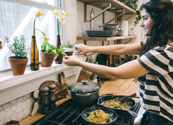 Woman managing weight by cooking a healthy meal with fresh ingredients