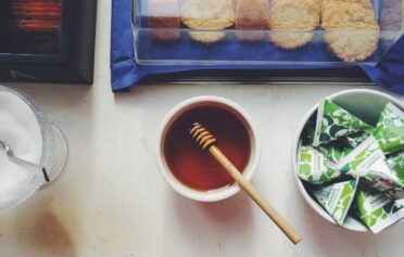 A bench with honey, biscuits, sugar and milk