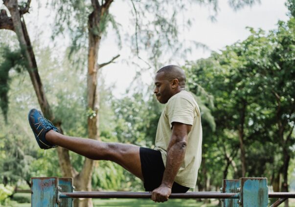 Man working out outside. Park in the gym.