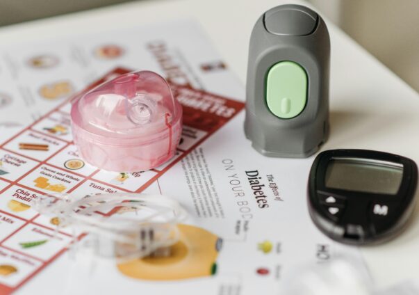 Diabetes management tools including an insulin pump, glucose meter, and dietary chart.