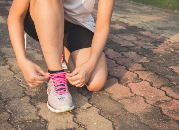 Person tying up the shoes.