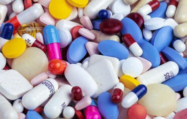 Colorful assortment of weight loss pills, capsules, and tablets.
