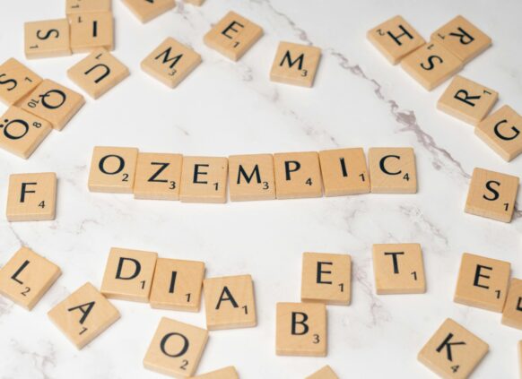 Wooden Scrabble tiles spelling out “Ozempic” surrounded by letters and the word “diabetes”