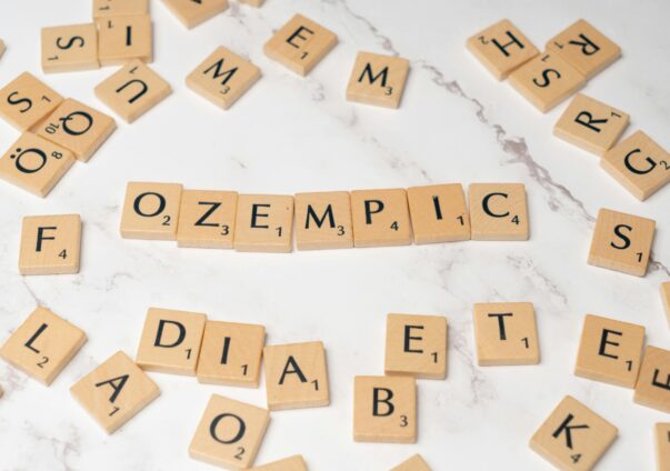 Wooden Scrabble tiles spelling out “Ozempic” surrounded by letters and the word “diabetes”