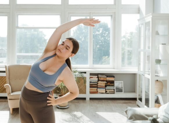 Woman stretching during a home workout in a bright living room