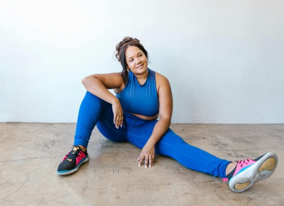 Woman in activewear sitting on the ground