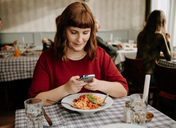 Woman taking a picture of her healthy meal