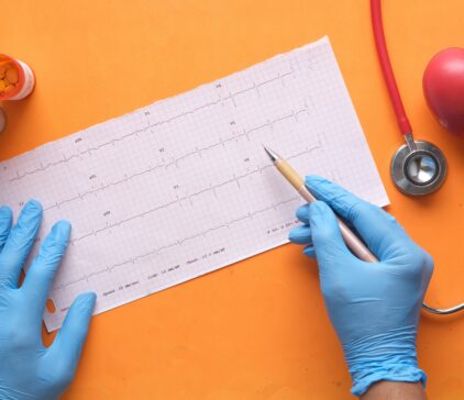 Medical professional reviewing medical document with blue gloves