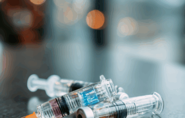 Three medical injections on a table