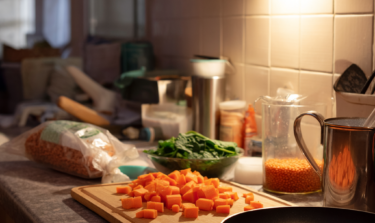 Ingredients on a countertop to make spinach and lentil soup