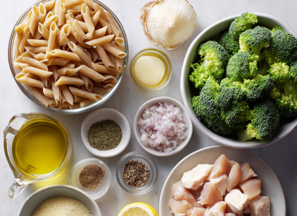 Ingredients for wholewheat chicken penne laid out on a kitchen bench