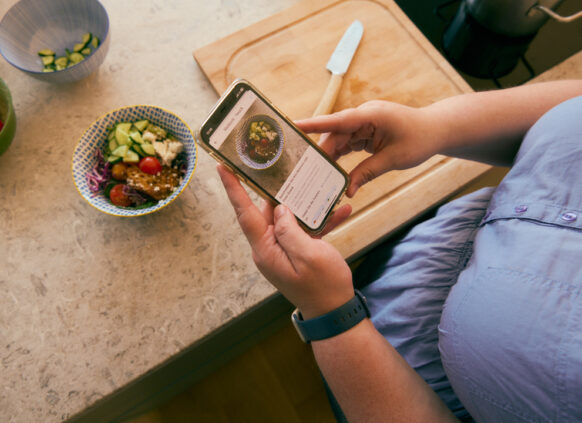 Woman adding meal to the Oviva app for tracking and insights