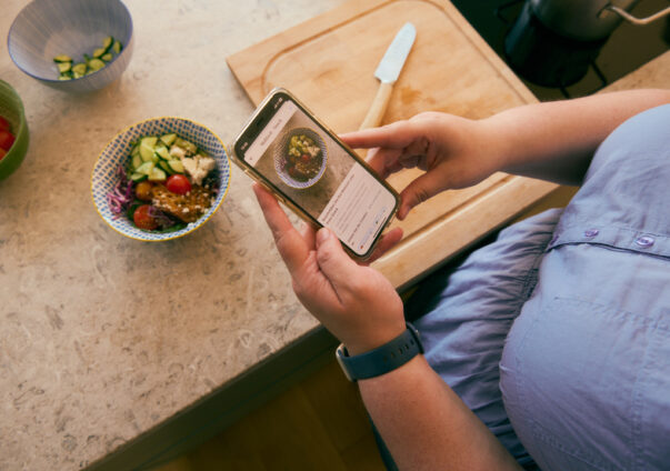 Woman adding meal to the Oviva app for tracking and insights