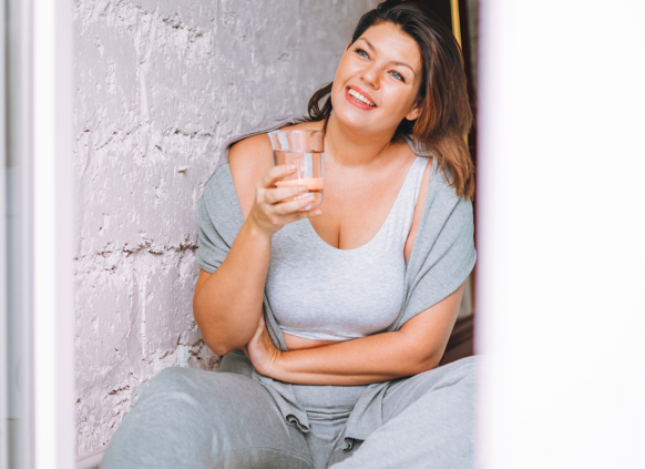 Woman drinking water and smiling