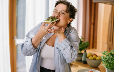 Woman happily eating a healthy meal
