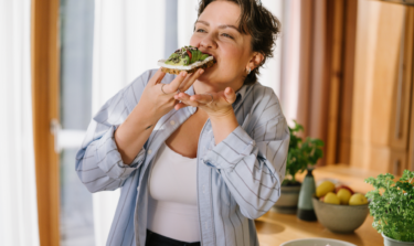 Woman happily eating a healthy meal