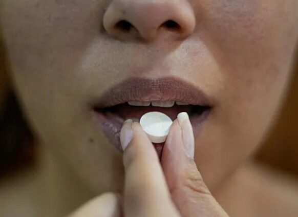 Woman taking weight loss pill