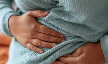 Woman holding her stomach with pain